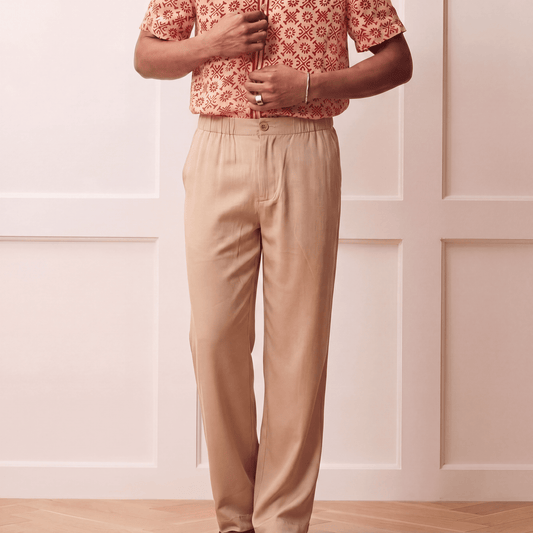 Close up of beige Tencel trousers showing elasticated back waistband and button front