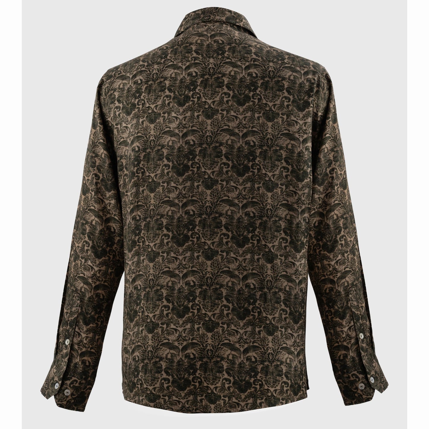Back view of brown abstract print button-up with silver cuffs