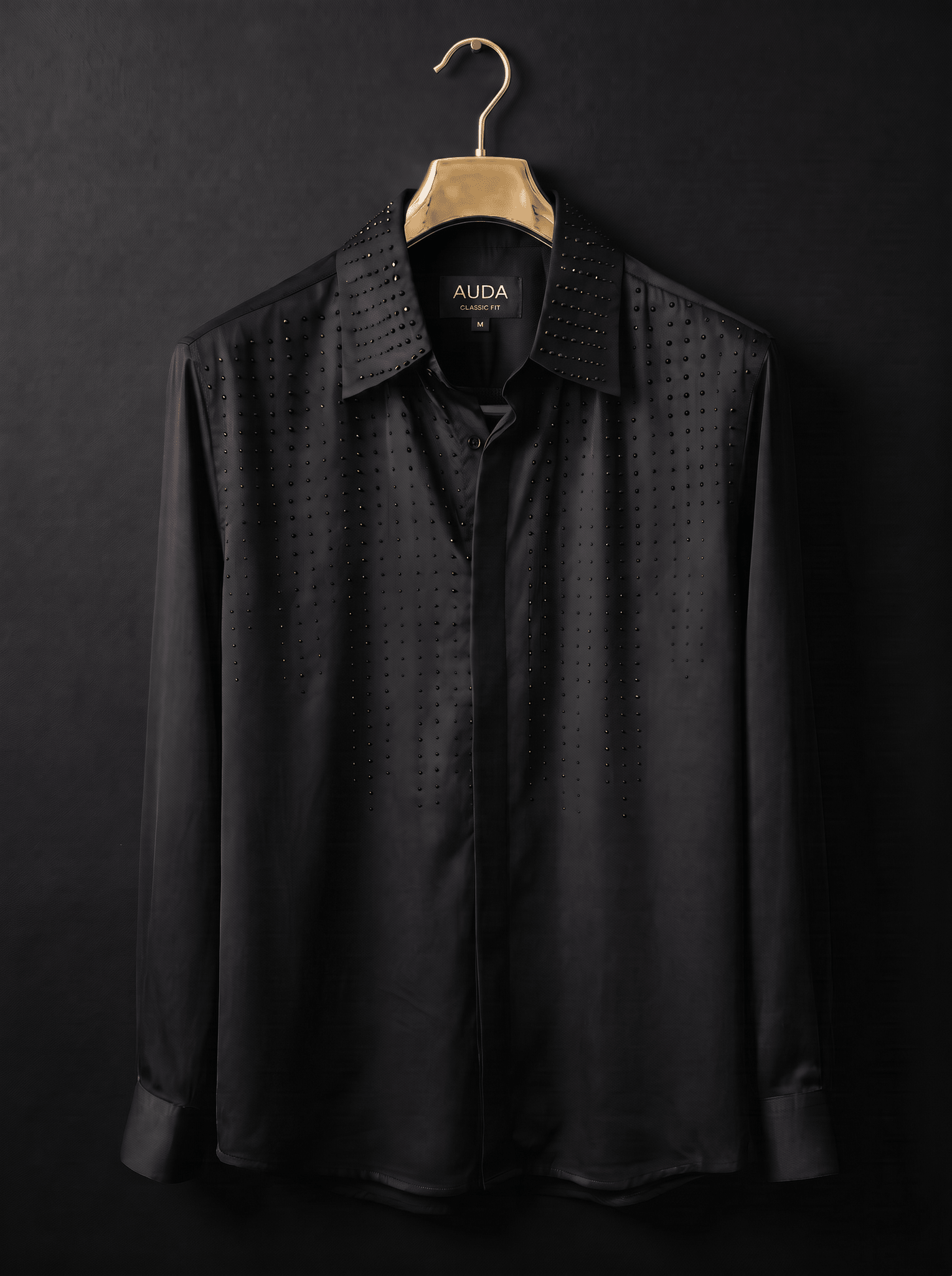 A black long-sleeve button-up shirt with a subtle perforated dot pattern and a studded collar, hanging on a gold hanger against a dark background. The brand name 'ALDA' is visible on the inner neck label.