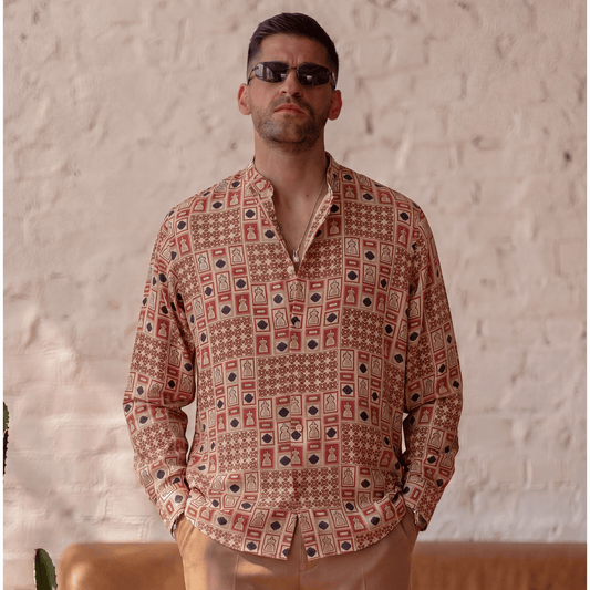 Fluid drape of long-sleeve printed viscose shirt styled with light brown trousers