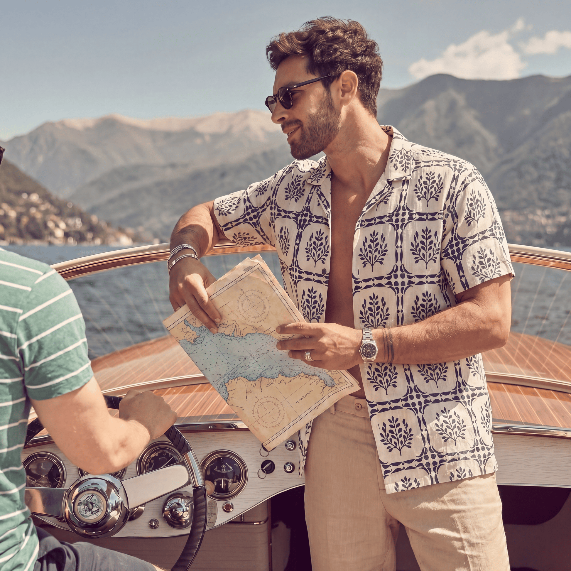 Man wearing white linen Cuban shirt with navy geometric leaf print on boat