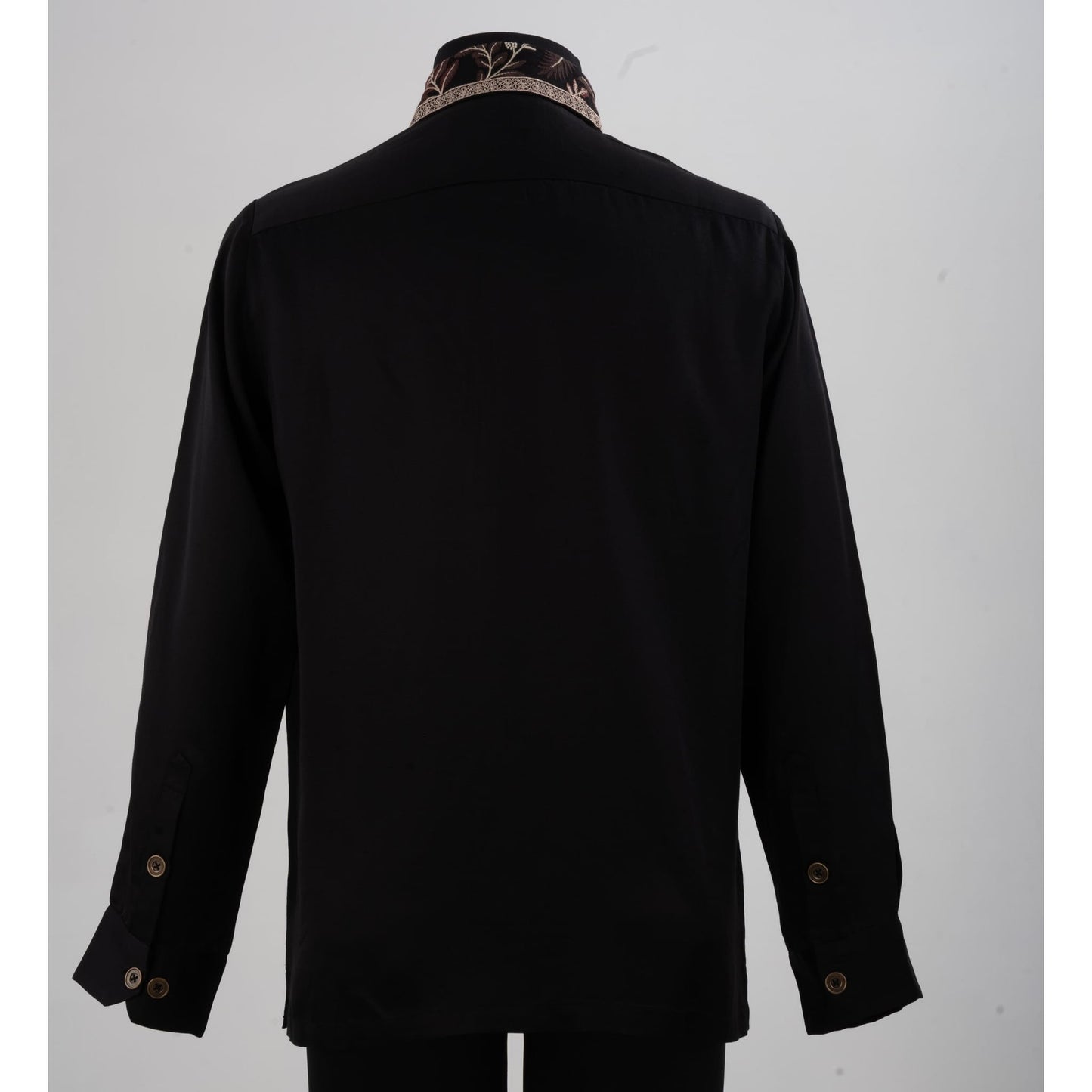 Back view of black linen-satin shirt showing smooth fabric and embroidered collar detail