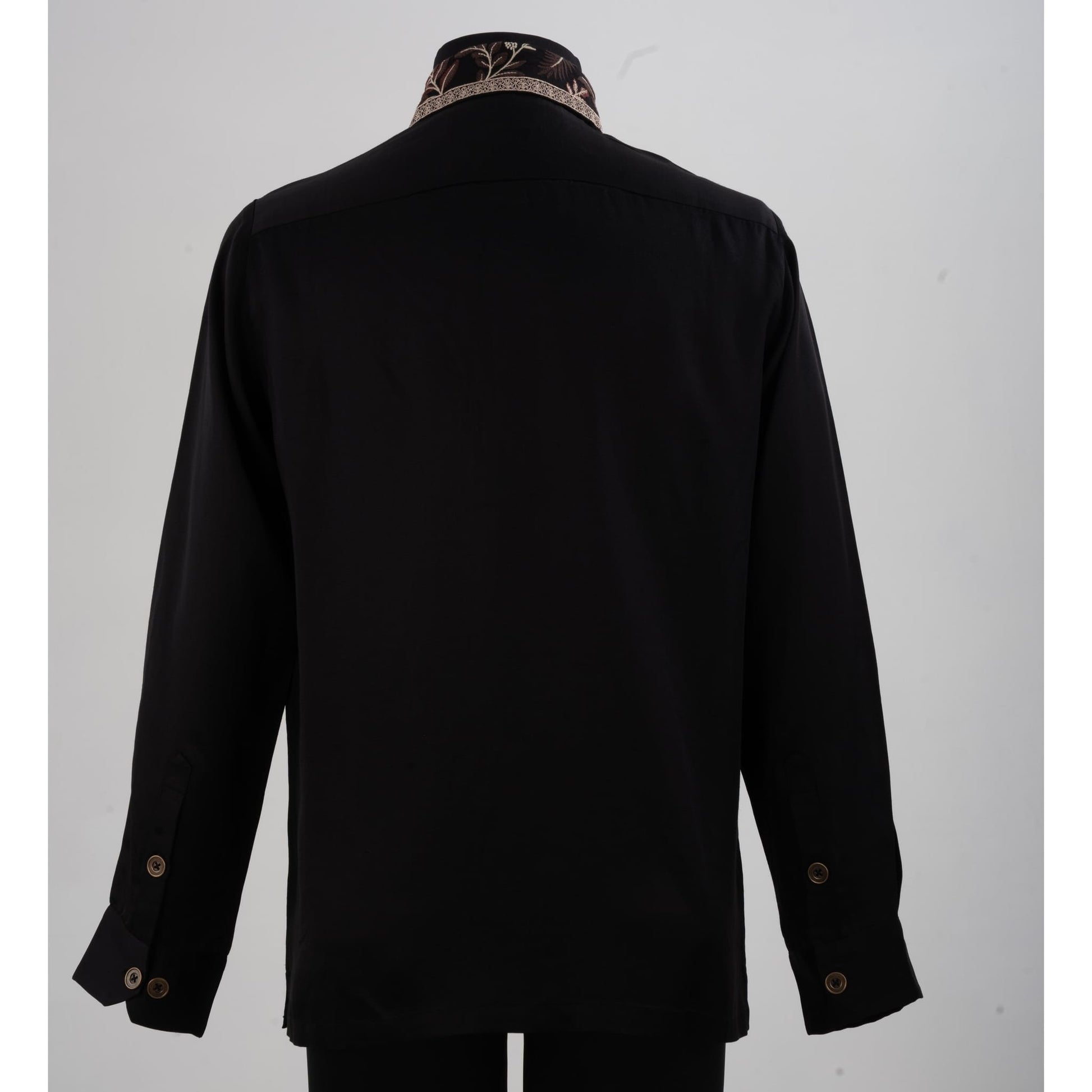 Back view of black linen-satin shirt showing smooth fabric and embroidered collar detail