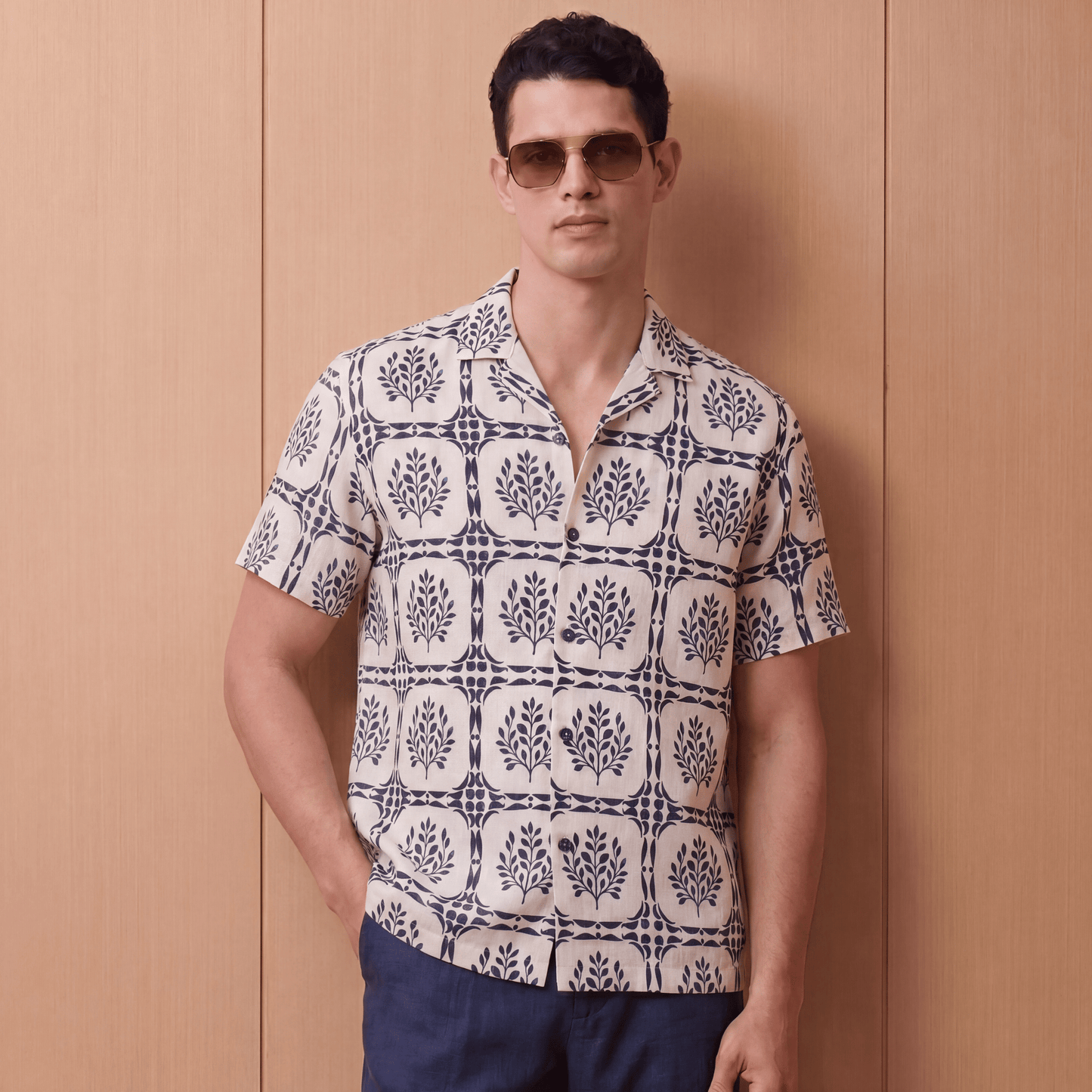 White short sleeve linen button up shirt with navy blue leaf pattern front view