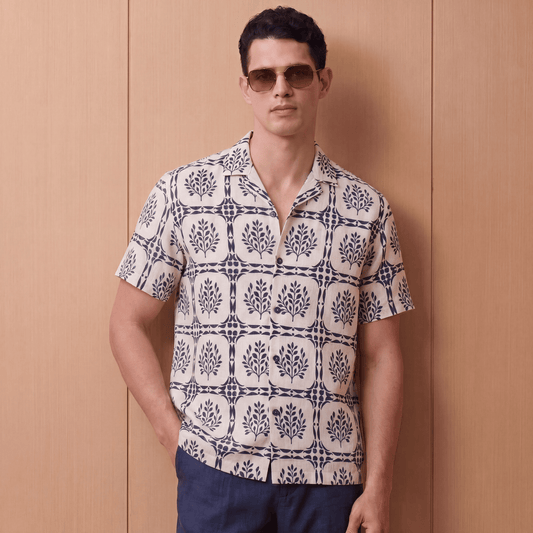 White short sleeve linen button up shirt with navy blue leaf pattern front view