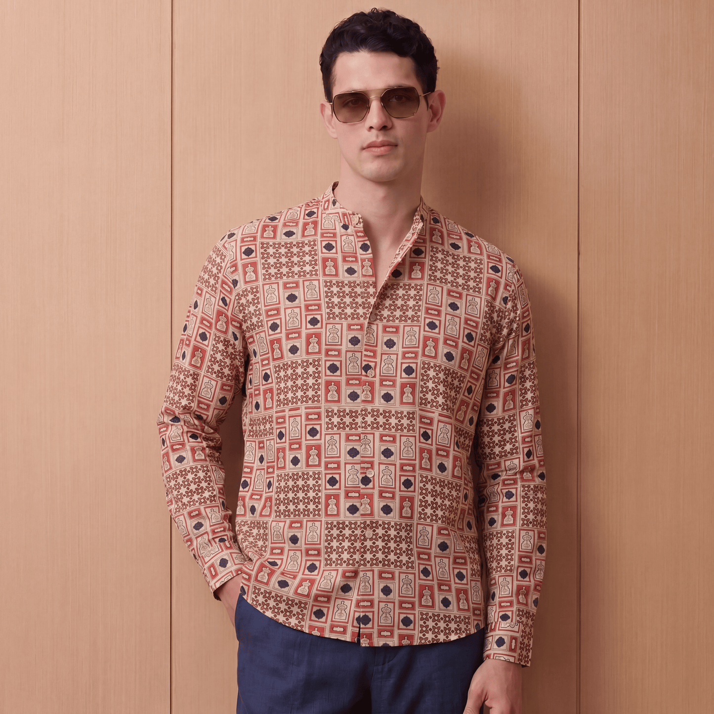 Man wearing relaxed fit terracotta and navy printed viscose shirt with trousers