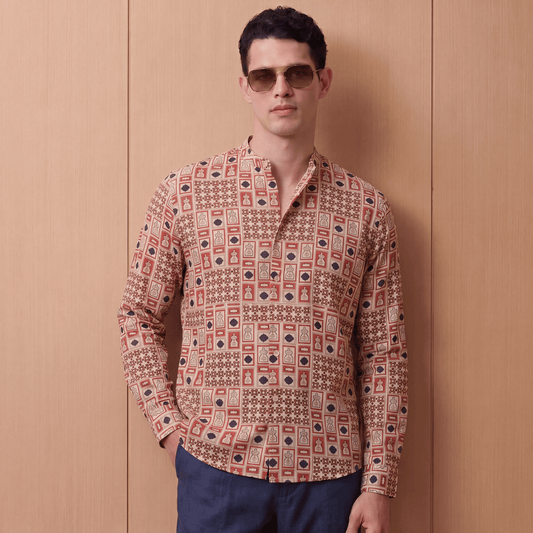 Man wearing relaxed fit terracotta and navy printed viscose shirt with trousers