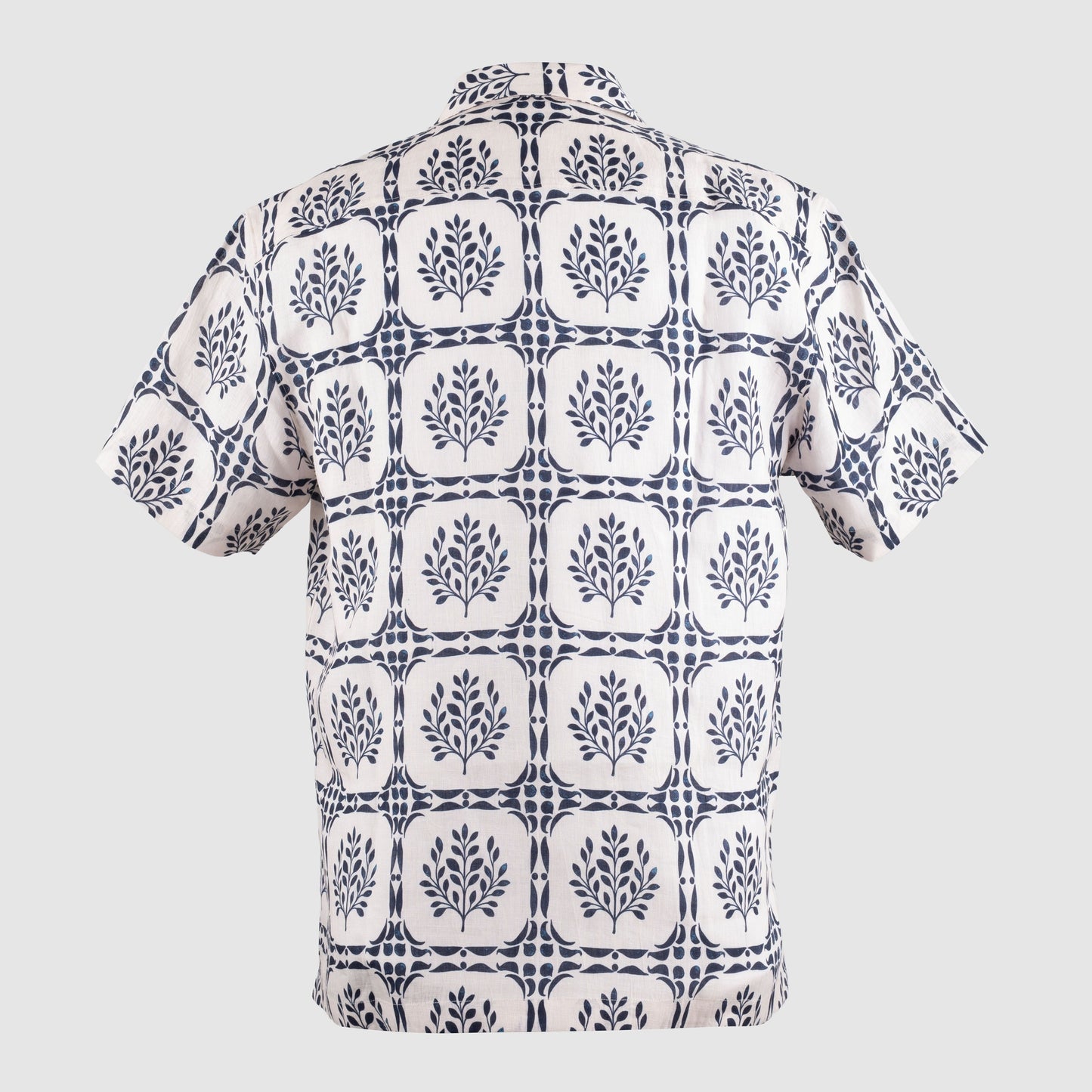 Back view of off-white linen Cuban shirt with indigo geometric leaf print