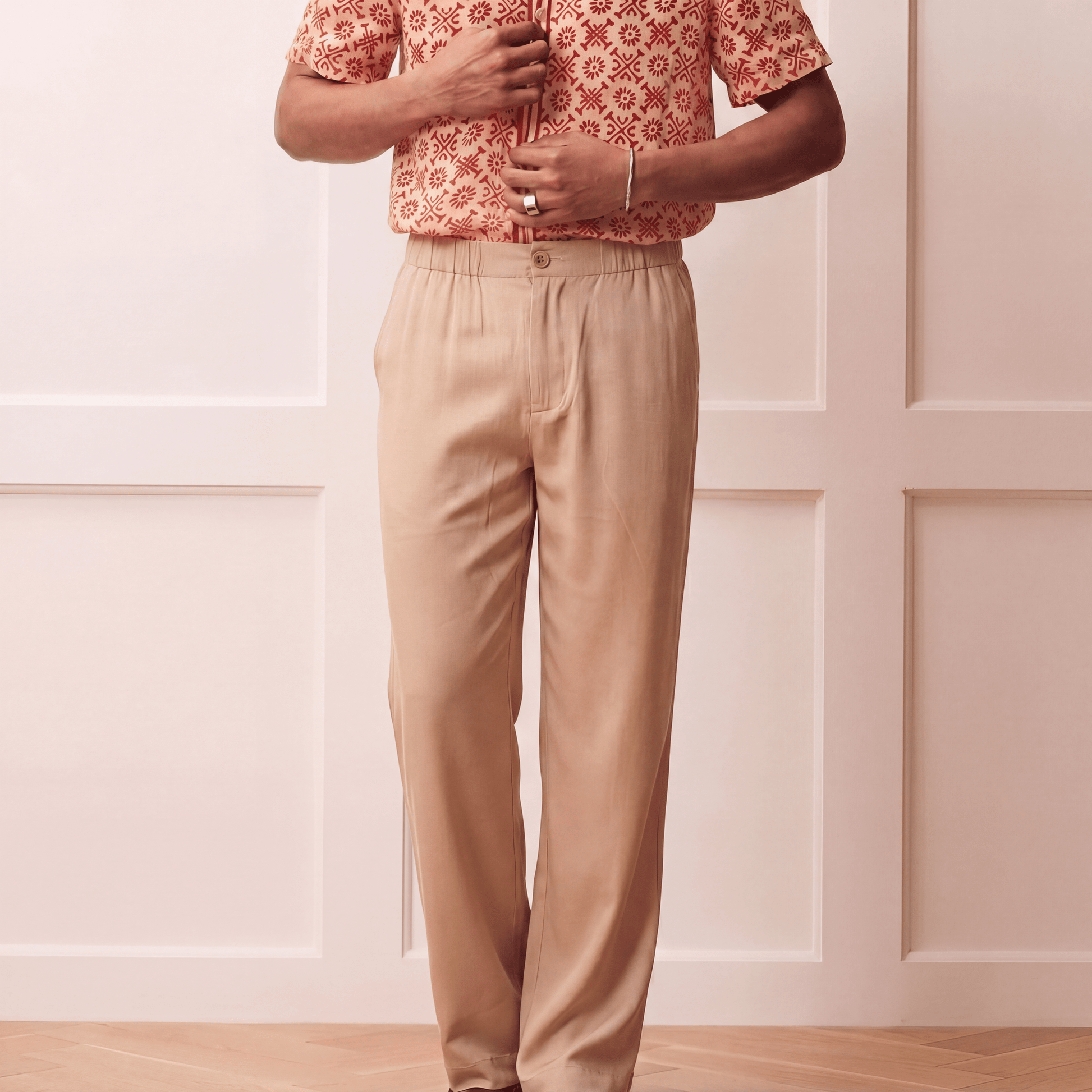 Close up of beige Tencel trousers showing elasticated back waistband and button front