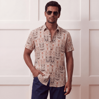 Short sleeve button-up viscose shirt styled with denim jeans