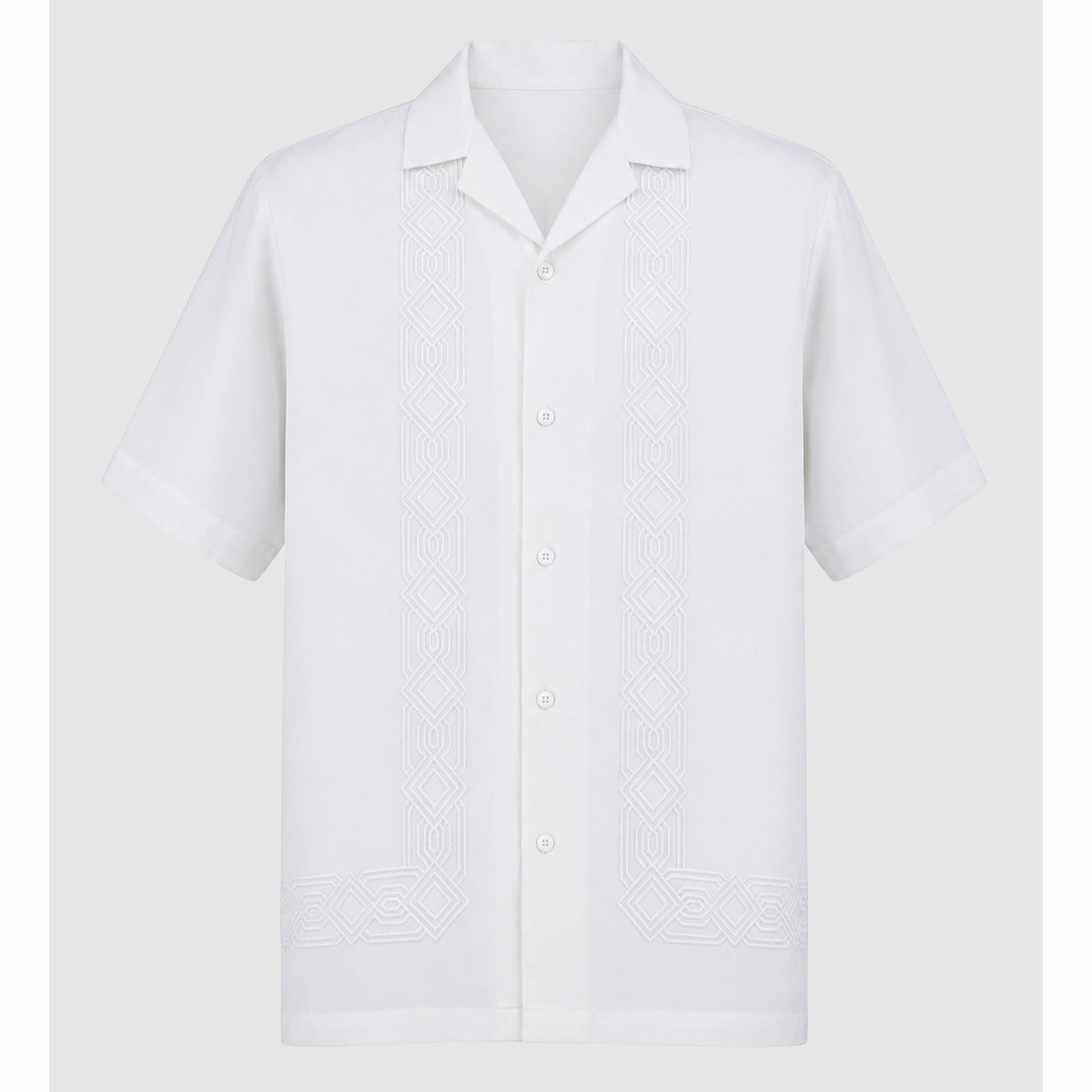 Flat lay of white short sleeve shirt with symmetrical front embroidery motifs