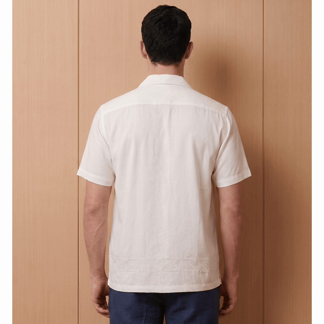 Man wearing relaxed fit white shirt with back embroidery design