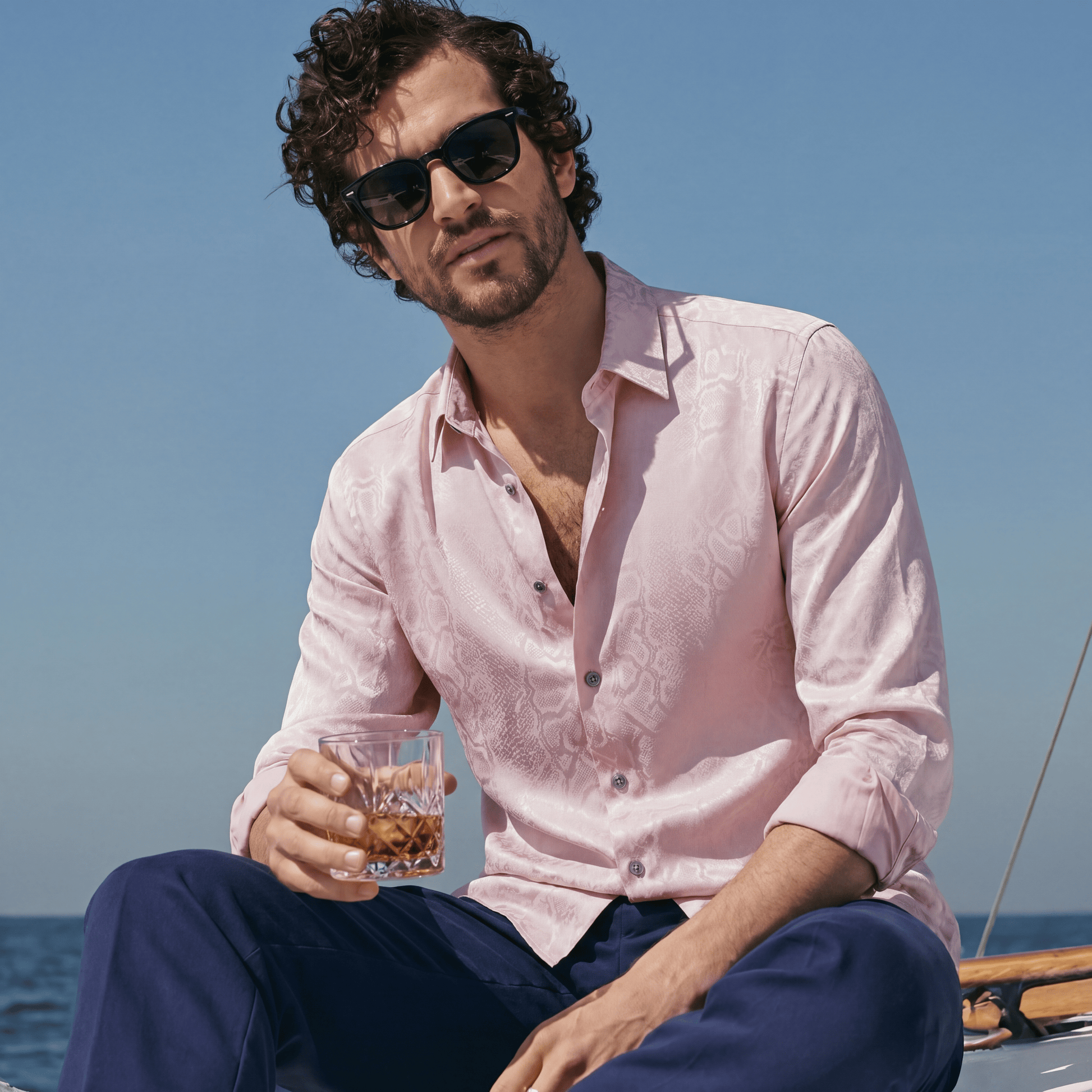 Pink viscose jacquard shirt rolled sleeves worn open on boat for summer soiree