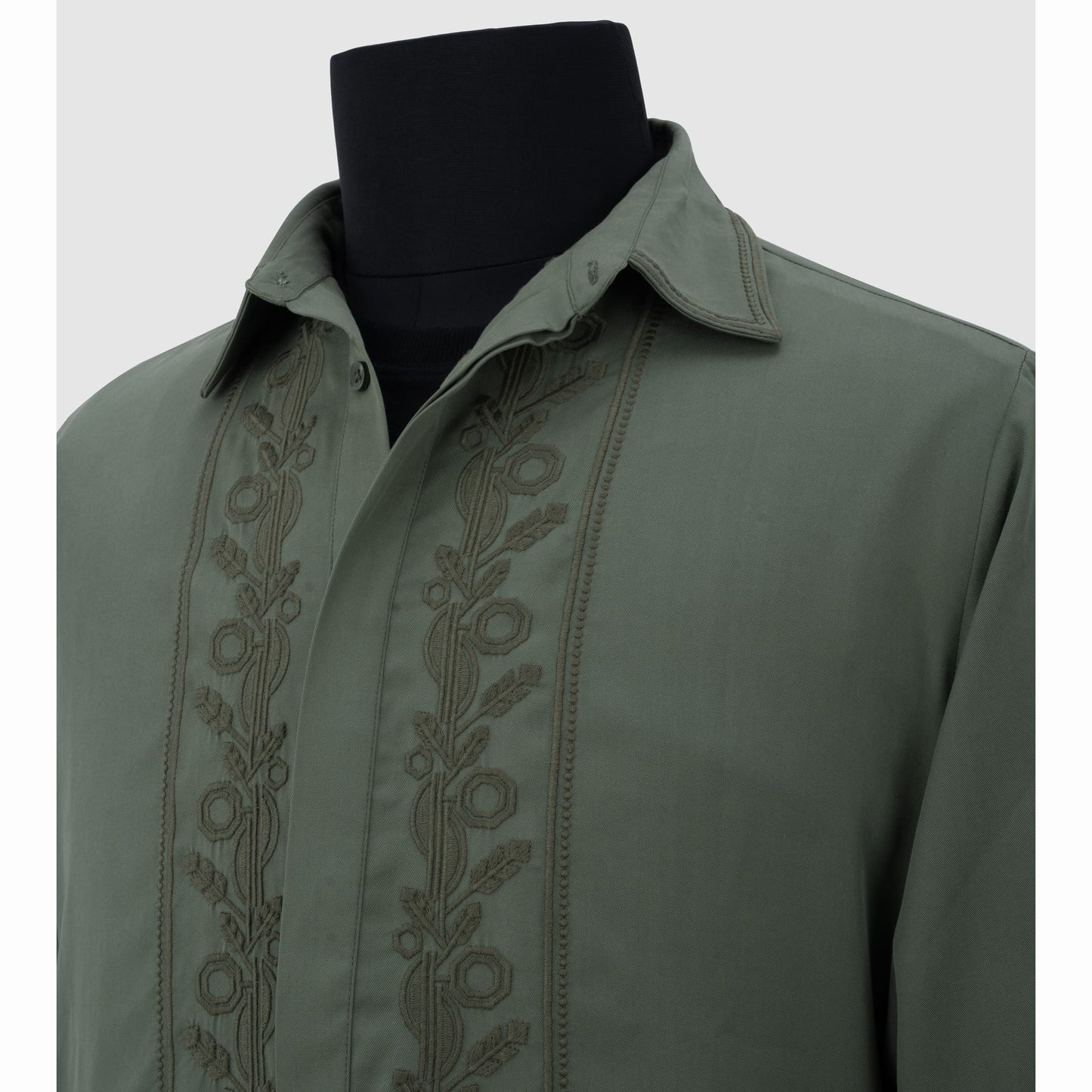 Close-up of tonal floral embroidery on olive Tencel shirt placket