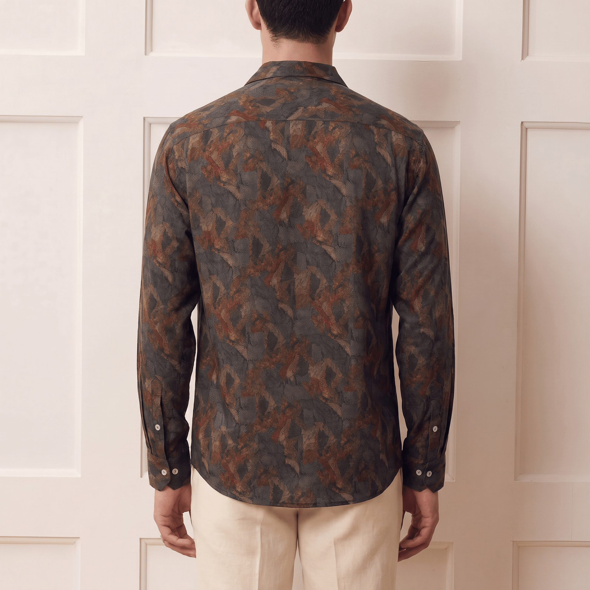 Back view of men's abstract expressionist print Cuban collar viscose shirt in earthy tones
