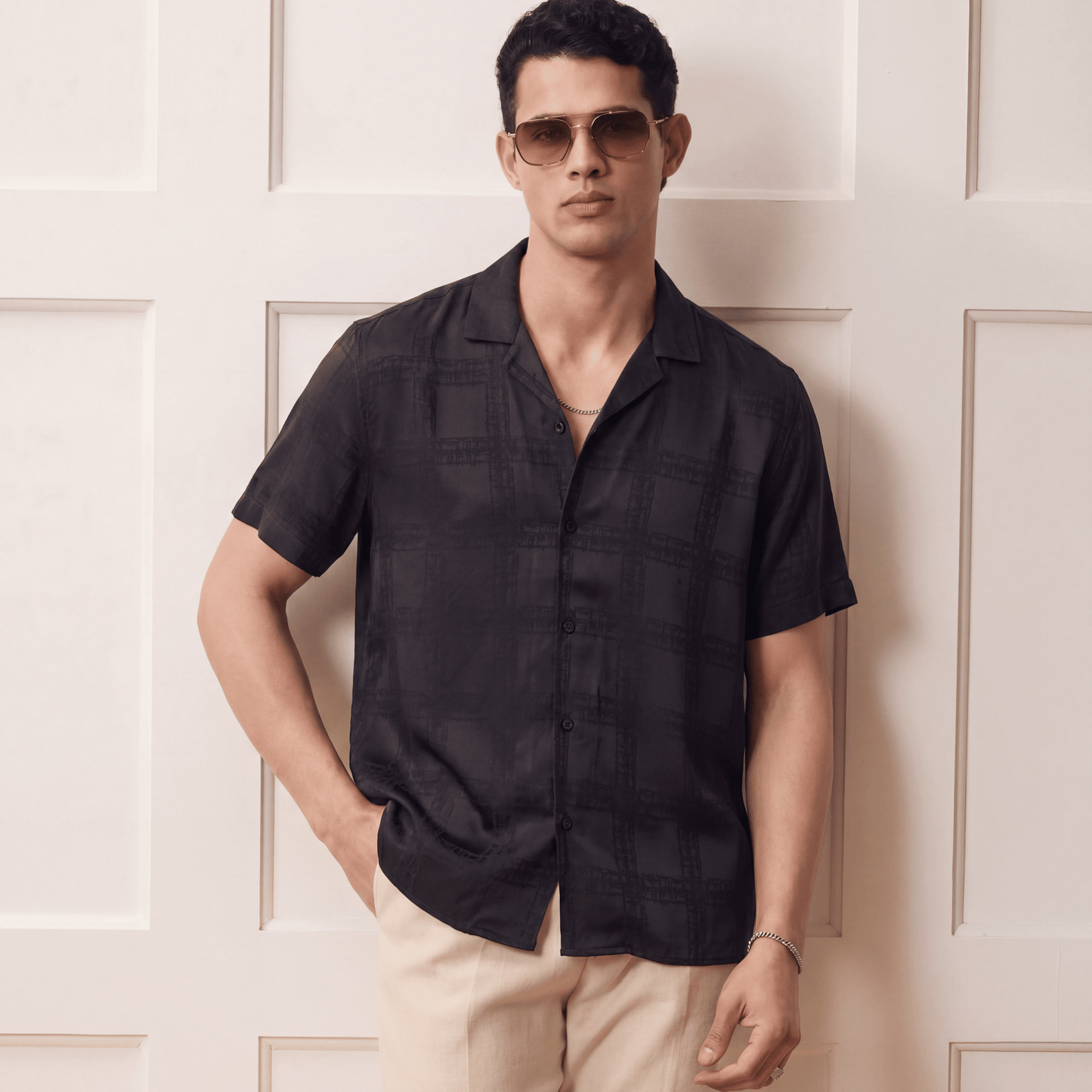 Man wearing dark gray relaxed fit viscose jacquard shirt with beige trousers