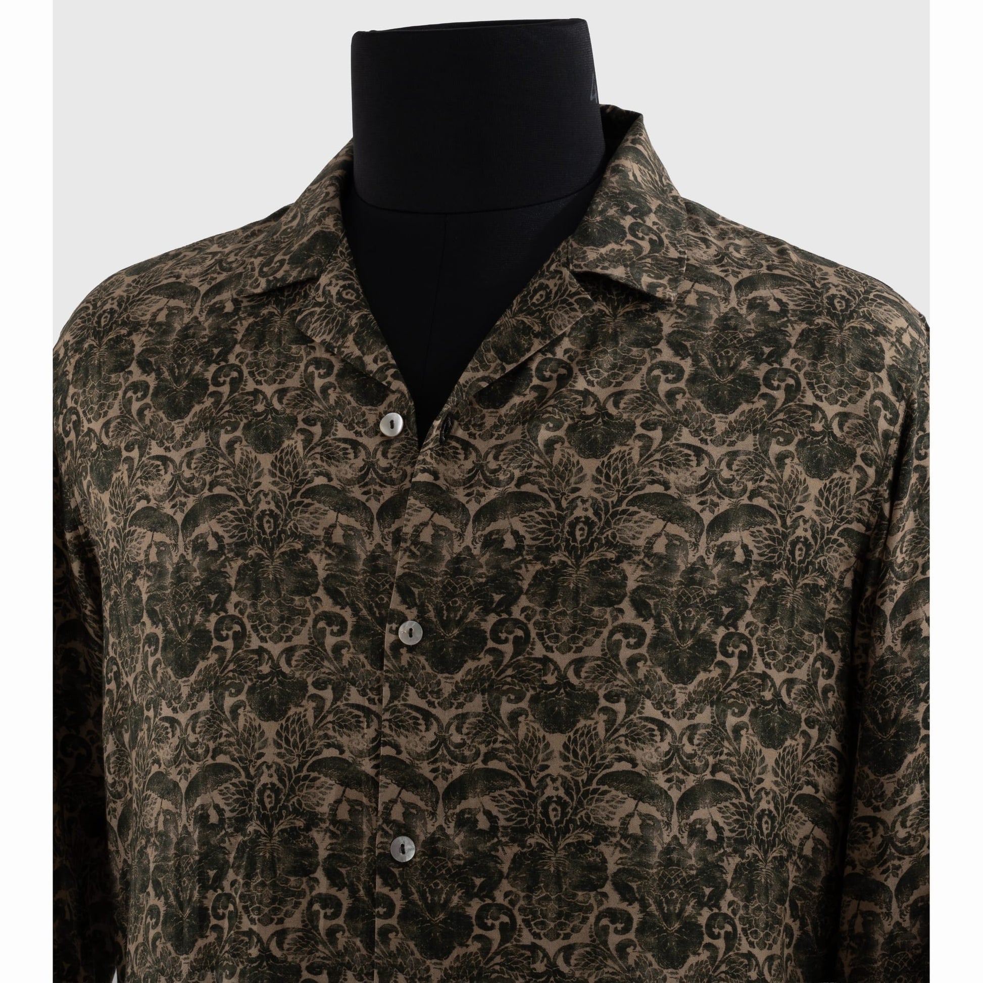Close-up of notched Cuban collar and metallic buttons on viscose shirt