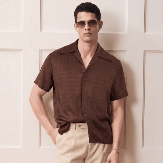 Man styling brown textured Cuban collar shirt with sunglasses
