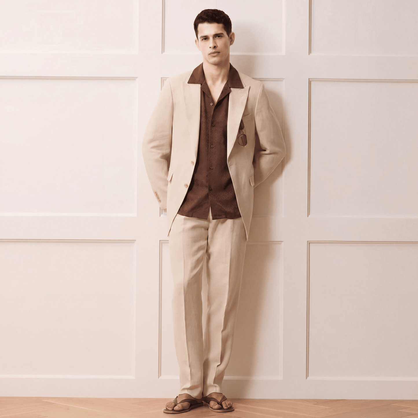 Man wearing brown jacquard Cuban shirt under beige suit jacket