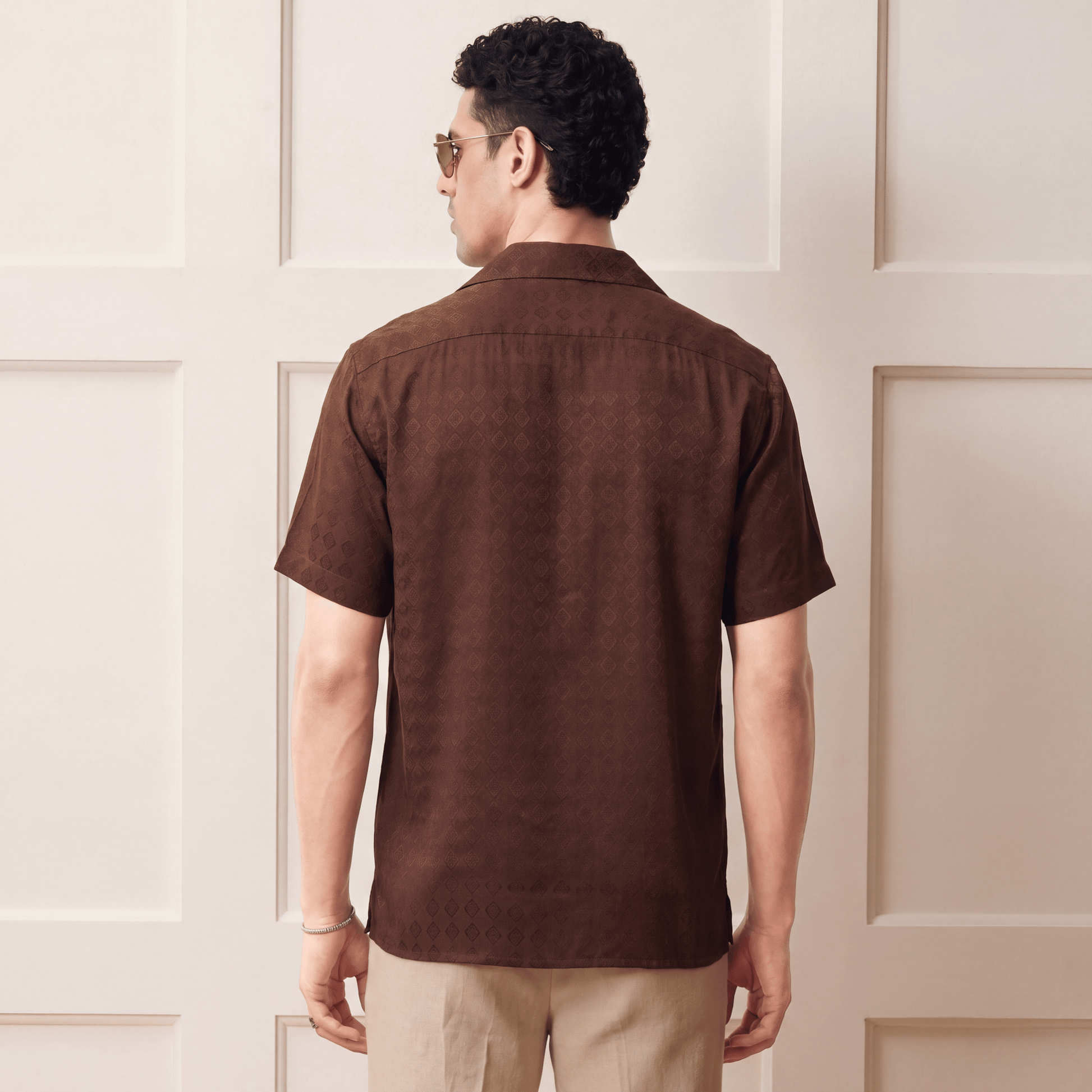 Back view of brown short-sleeve Cuban collar shirt on man