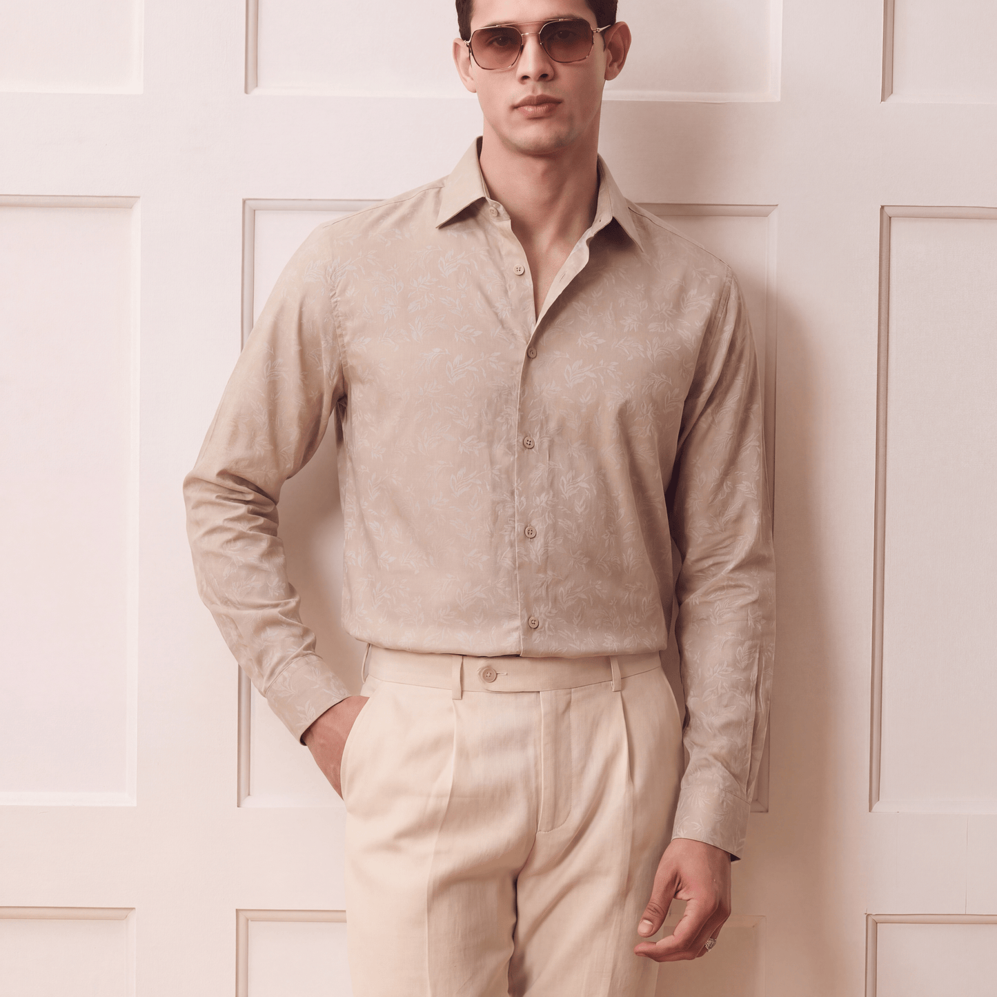 Men's light beige self-jacquard button-up shirt with regular collar and pleated trousers