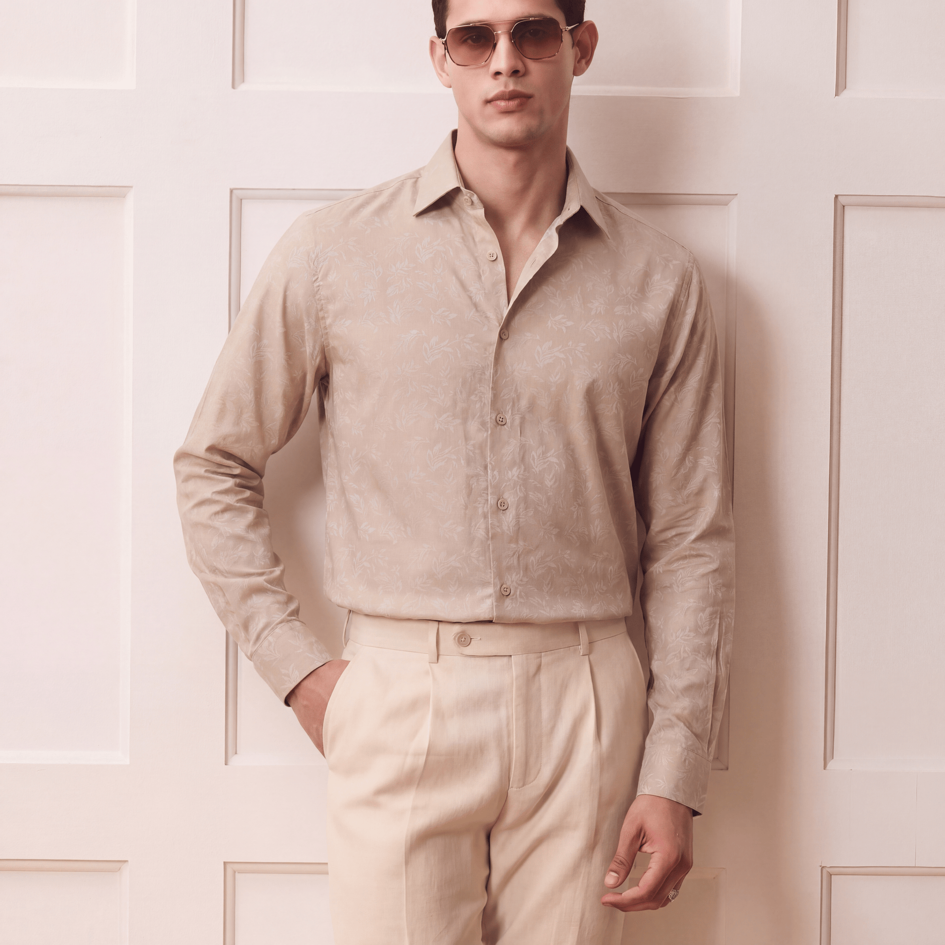 Men's light beige self-jacquard button-up shirt with regular collar and pleated trousers