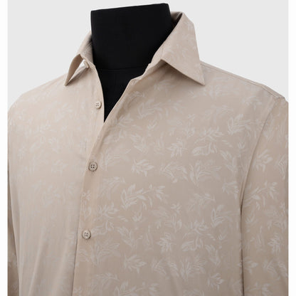 Close-up of light beige cotton shirt featuring subtle white leafy jacquard weave detail